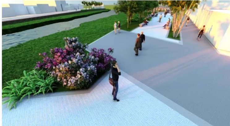 A imagem mostra uma renderização arquitetônica de um espaço público. Há um caminho largo e pavimentado de cor clara que serpenteia pela área, cercado por vegetação exuberante e flores vibrantes em tons de rosa, roxo e branco. Várias pessoas estão espalhadas pela cena; algumas estão caminhando sozinhas, enquanto outras estão em pequenos grupos, parecendo estar conversando. O ambiente sugere um cenário ao ar livre sereno, projetado para passeios tranquilos e relaxamento. O céu não é visível na imagem, indicando que o foco está na interação entre as pessoas e o ambiente paisagístico.