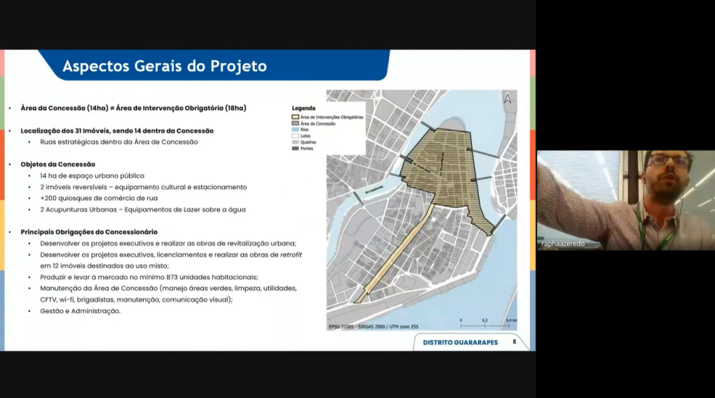 Captura de tela de apresentação online que mostra como será projeto de revitalização urbana no Distrito Guararapes envolve uma área de concessão de 14 hectares, próxima à área de intervenção obrigatória de 18 hectares, onde estão localizados 31 imóveis, sendo 14 dentro da concessão em ruas estratégicas; os objetos da concessão incluem a gestão de 14 hectares de espaço público, dois imóveis reversíveis (um equipamento cultural e um estacionamento), mais de 200 quiosques de comércio de rua e duas “acupunturas urbanas” voltadas ao lazer sobre a água; entre as principais obrigações do concessionário estão elaborar projetos executivos, realizar obras de revitalização e retrofit em 12 imóveis de uso misto, produzir ao menos 873 unidades habitacionais, além de manter toda a área de concessão com serviços de limpeza, áreas verdes, utilidades, segurança, comunicação visual e administração geral.